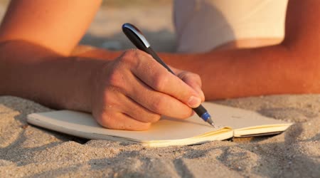 depositphotos_33445497-Man-writing-in-his-diary-at-the-beach